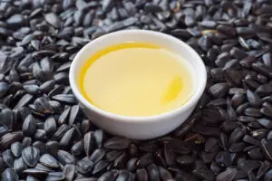 Background of sunflower seeds and sunflower oil.